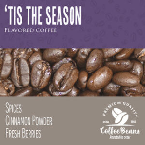 A close up of coffee beans with the words " tis the season flavored coffee " underneath.