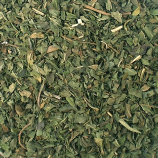 A pile of Herbal Peppermint Tea leaves on a table.